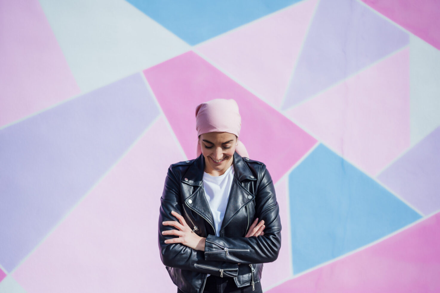 Portrait of woman with pink headscarf, has cancer